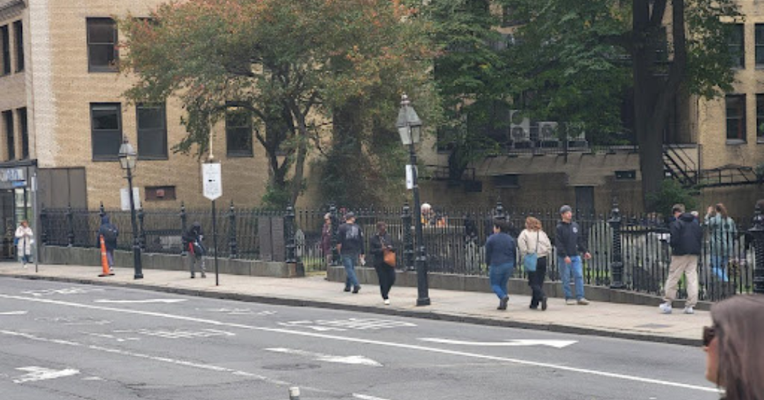 The King's Chapel Burying Ground fence as it looks in October 2024. Although the passersby’s outfits are different, the fence remains the same. A preservation success!