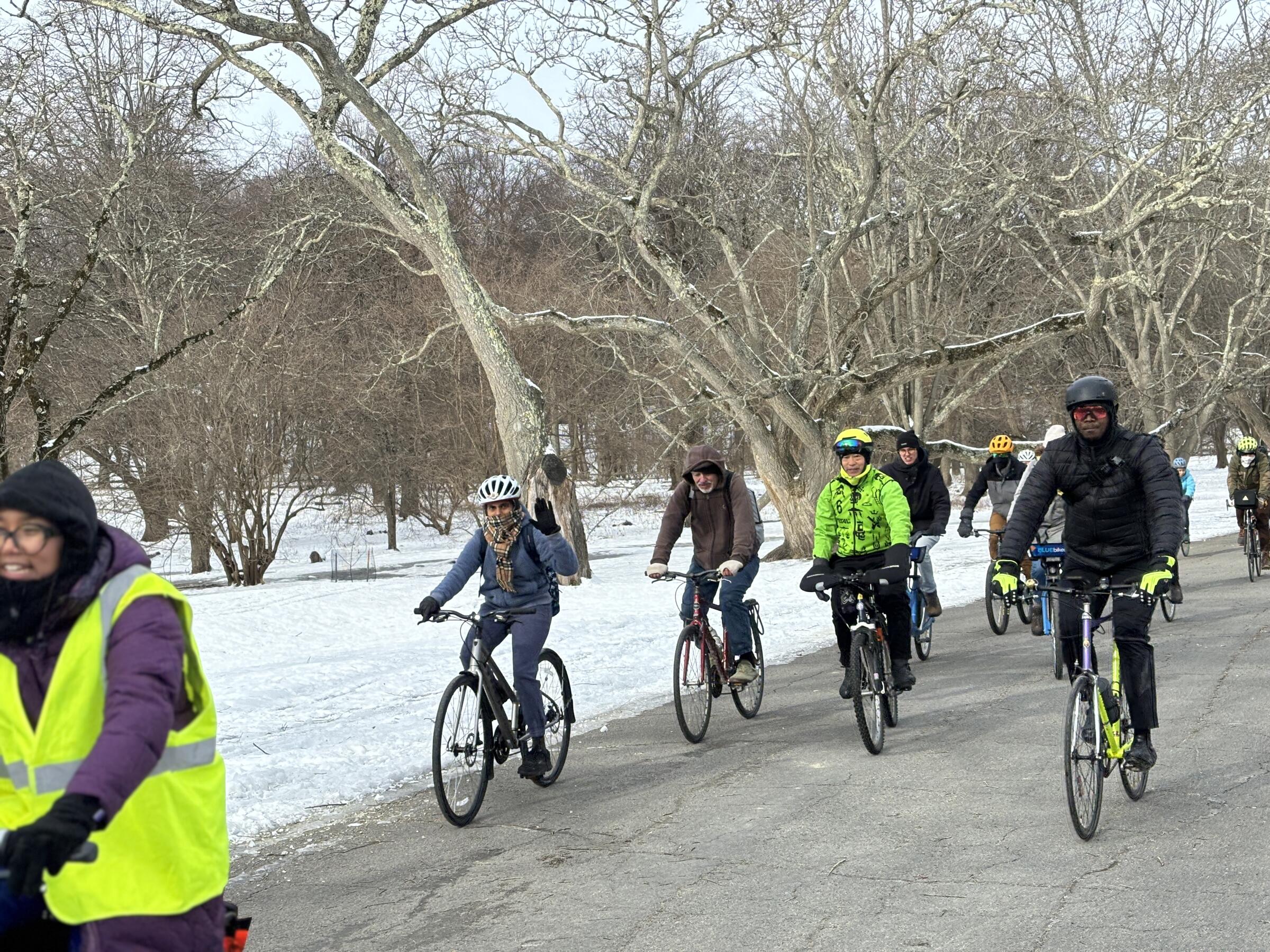 a group of cyclists riding in winter