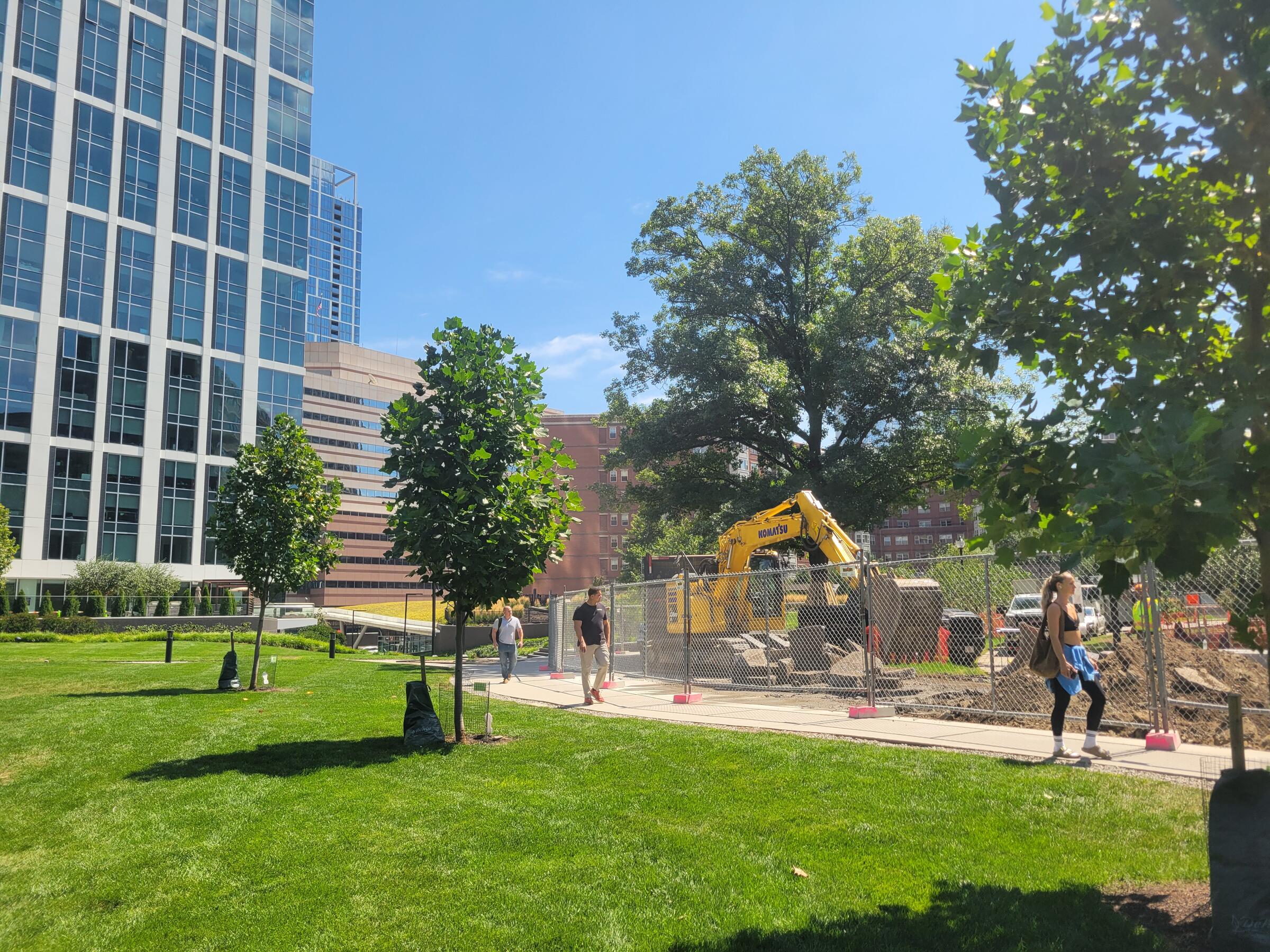 Path excavation in progress in the work zone with pedestrians in temporary access area on August 20, 2026.