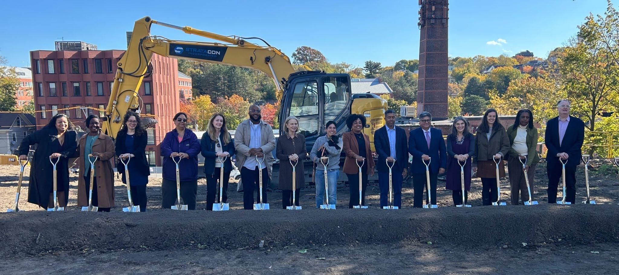 A group of 15 people with shovels celebrating the groundbreaking at Mission Hill Pathway.