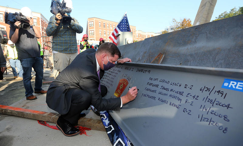 Mayor Walsh signing the firehouse beam