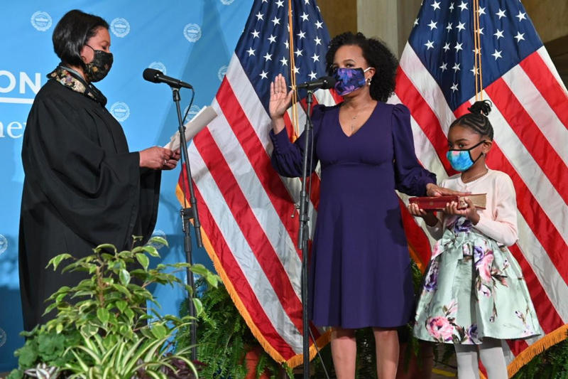 Mayor Kim Janey is sworn in by Chief Justice Kimberly Budd, with her granddaughter Rosie holding a Bible