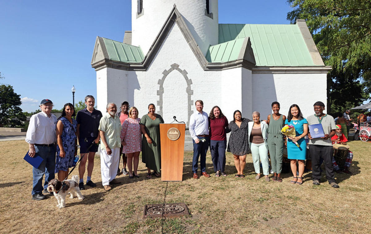 Highland Park community photo with elected officials in front of Highland Park water tower