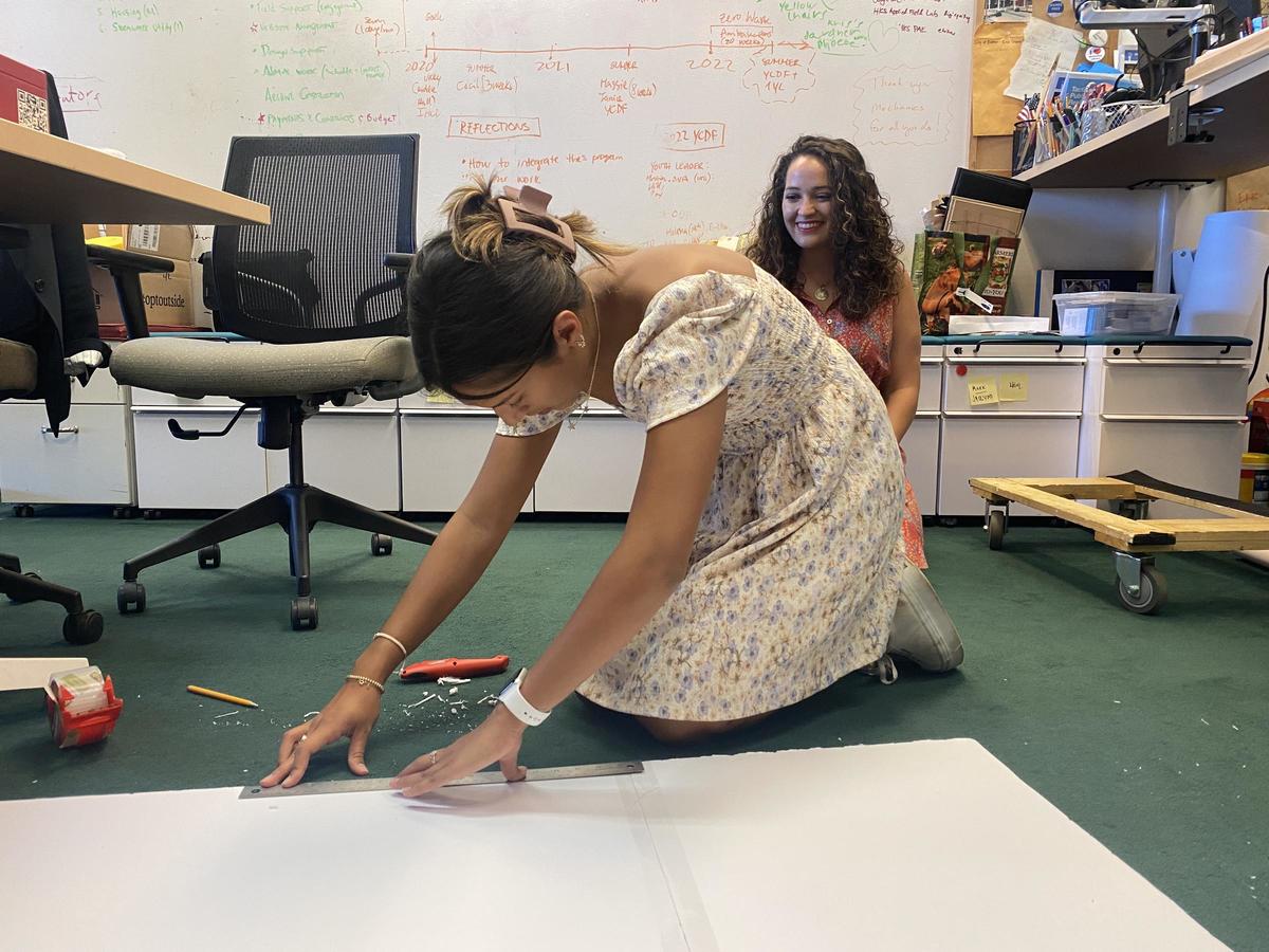 Image of a youth civic design fellow cutting foam core