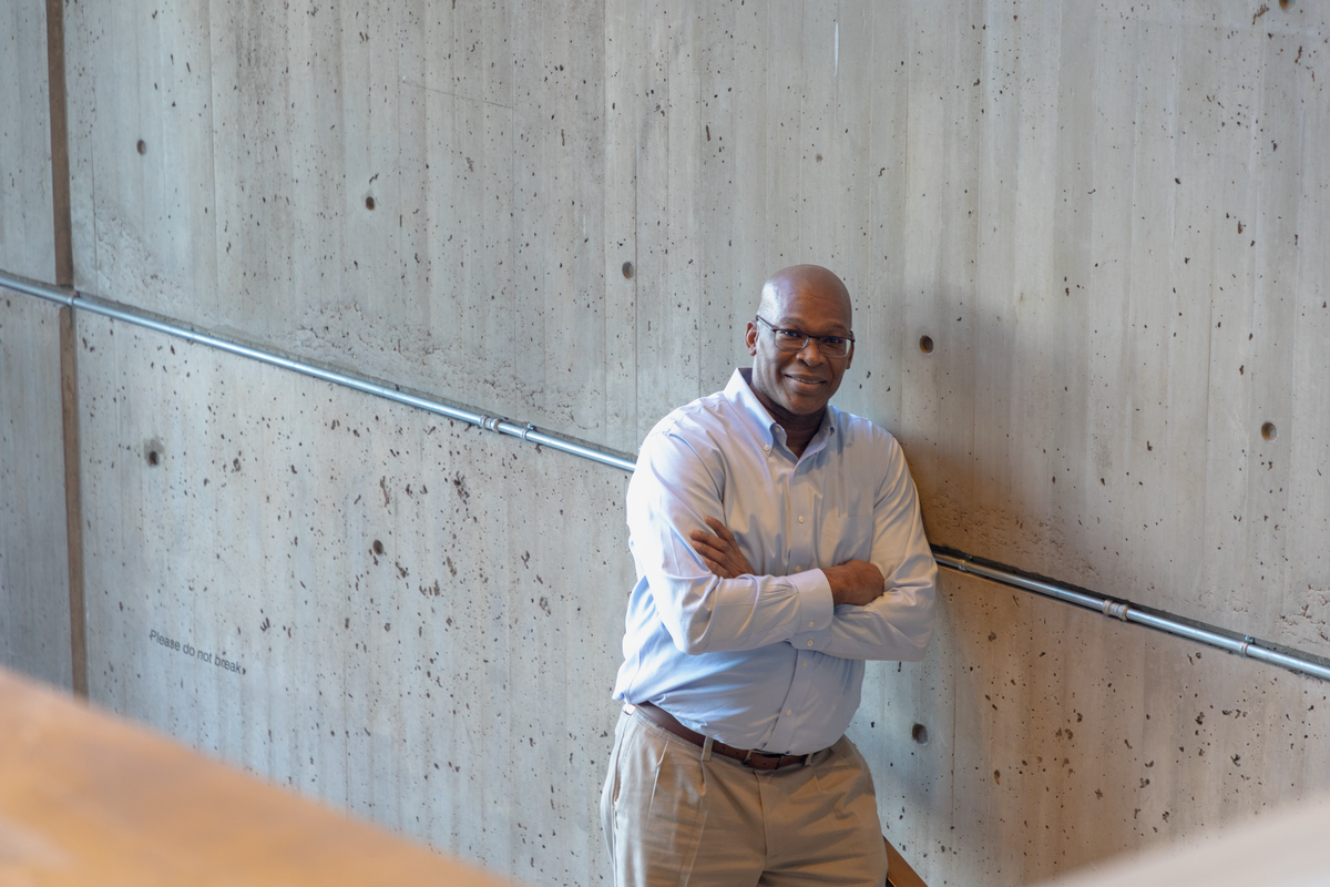 Fitzroy Brown in City Hall standing and smiling.