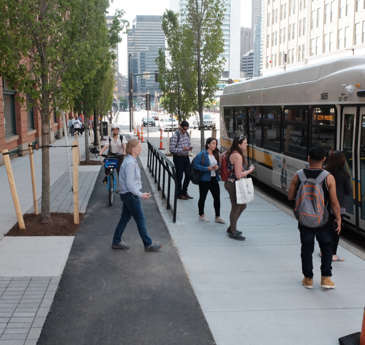 Bus riders boarding a MBTA Route 7 bus from a floating bus stop on Summer Street