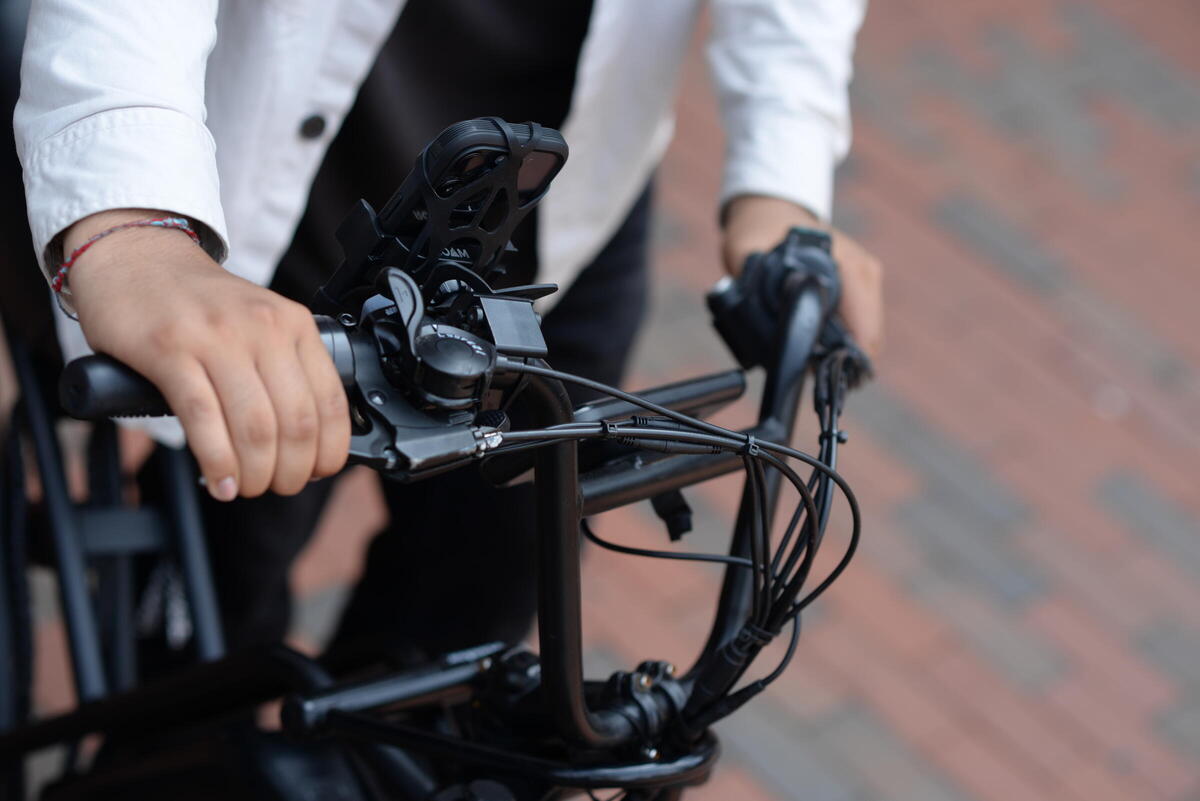 a photo of a person engaging brake levers on their e-bike