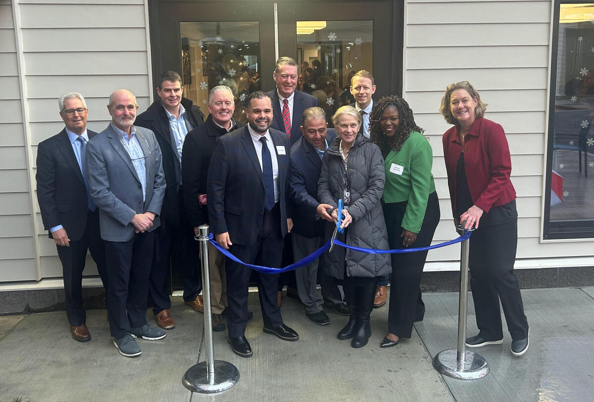 Chief of Housing Sheila Dillon cuts the ribbon on Logan Square Residence's opening day