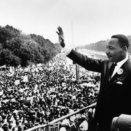 Image of Rev. Dr. Martin Luther King, Jr. waving to crowd