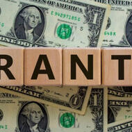 Dollar bills, grants scrabble pieces