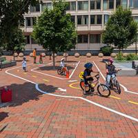 kids ride bikes on the bike town at city hall plaza