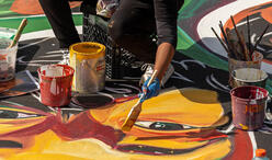 Artist Sydney G. James paints a basketball court in Malcolm X Park